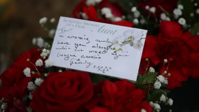 A message inside a floral tribute is pictured.