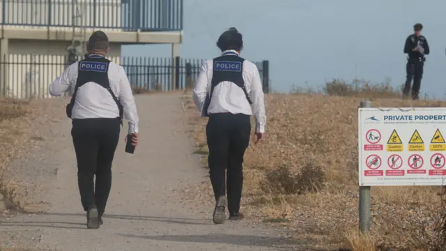 The back of two police officers walking