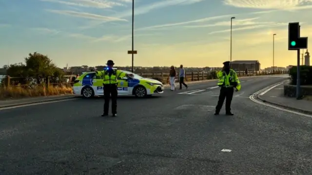 Two police officers and a police car
