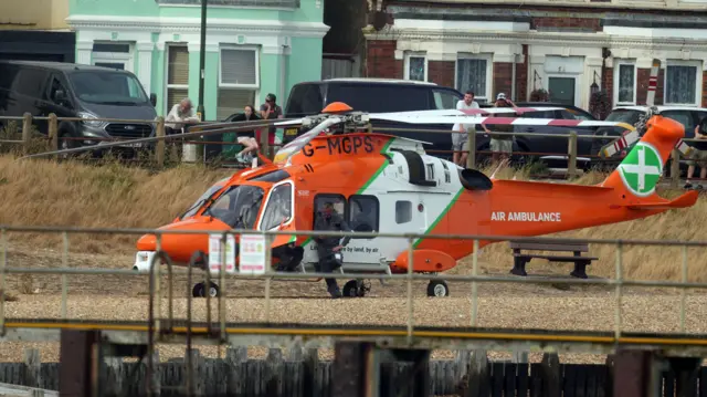 An orange and white air ambulance helicopter
