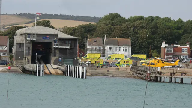 Long range shot of a lifeboat station with a number of emergency services next to it.