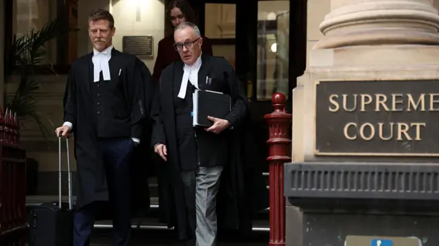 Brendan Kissane and Jeremy McWilliams walking out of the supreme court building