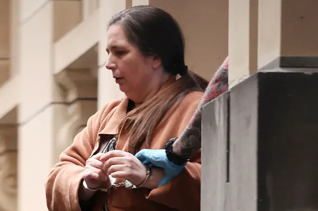 A picture of Erin Patterson in handcuffs