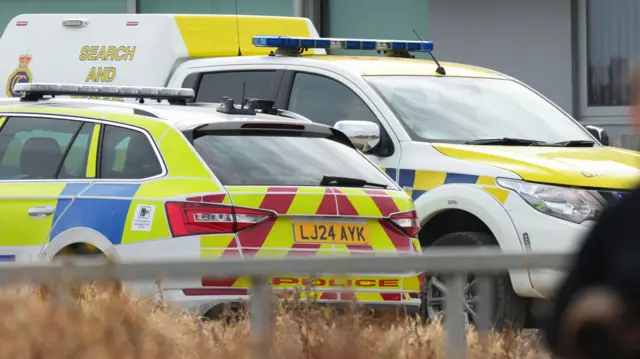 A police car and search and rescue vehicle.