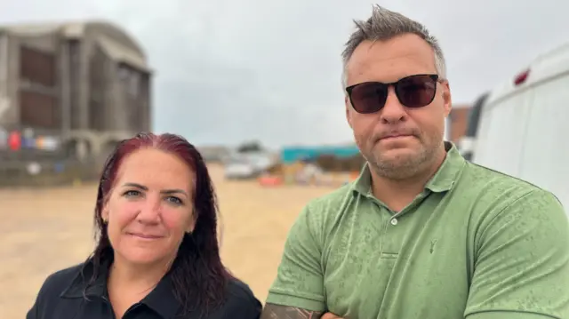 Friends Liz Donnelly and Lee Smith pictured in Shoreham-by-Sea. A woman is stood next to a man. They both are looking directly at the camera.