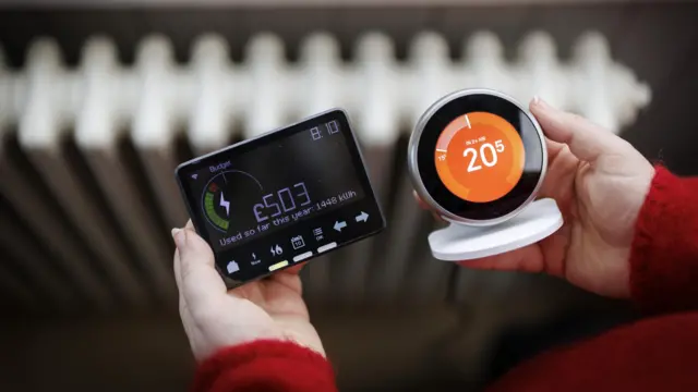 A person holds a smart energy meter