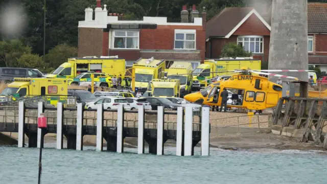 A large number of ambulances and a helicopter on a residential street close to the beach in Shoreham.