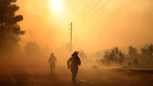 Firefighters battle a wildfire near the Agia Paraskevi village, Greece
