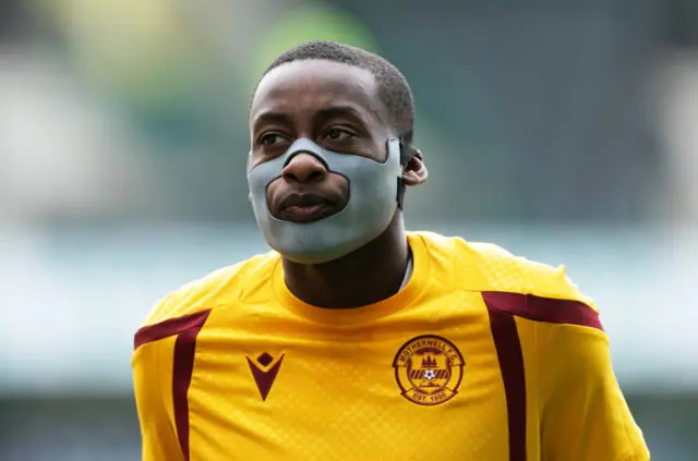 Tawanda Maswanhise continues on the Motherwell bench with a protective cover on his injured jaw