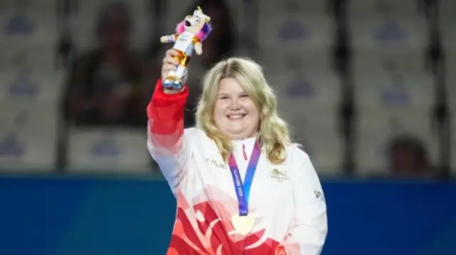 Katherine Rednall celebrates receiving her bowls gold medal