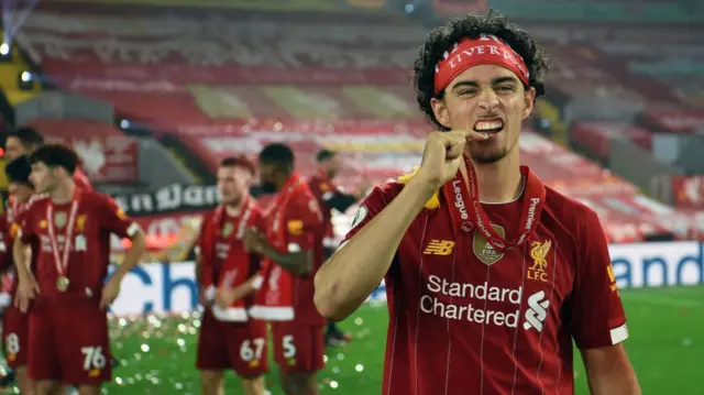 Curtis Jones bites Premier League medal