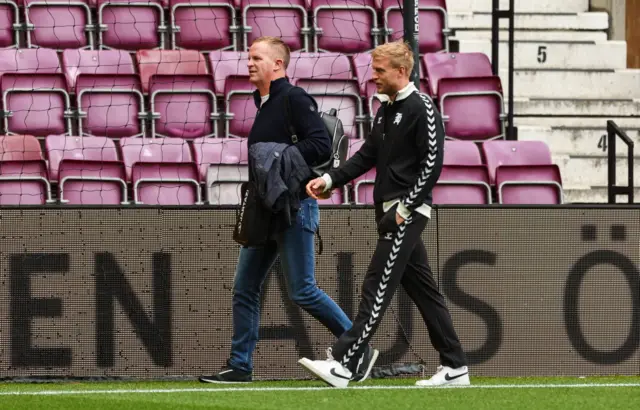 Hearts Head Coach Wouter Vrancken (L) and Harry Milne (R) before a UEFA Conference League Playoff Round First Leg match between Heart of Midlothian and Rapid Vienna, at Tynecastle Park, on August 20, 2026, in Edinburgh
