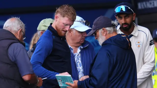 Ben Stokes signs some autographs