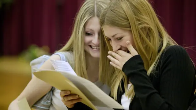 Two school girls celebrating their success in their GCSE exams in a school in Shropshire.