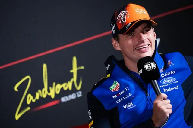 Max Verstappen with an FIA microphone in his hand