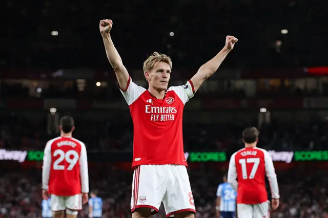 Martin Odegaard with his hands in the air