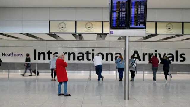 People wait for passengers in International Arrivals at Heathrow Terminal 5