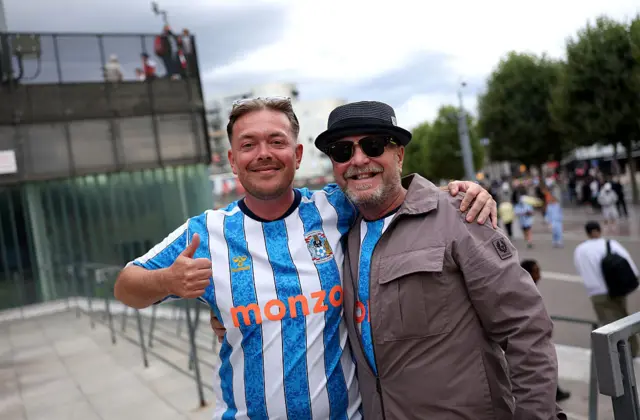 Fans of Coventry City pose for a photo outside the stadium before the Premier League 2026/27 match between Arsenal FC and Coventry City at Emirates Stadium on August 21, 2026 in London, England.