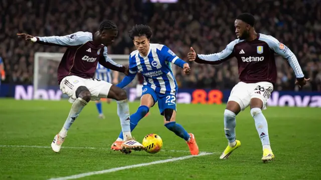 Kaoru Mitoma holds off the challenge of two Villa players