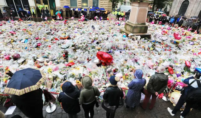 People observing a minutes silence in Manchester in honour of the 2017 London Bridge terror attack victims