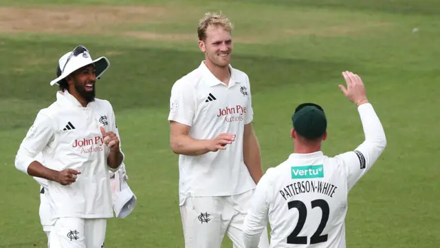 Dillon Pennington (centre) flanked by Haseeb Hameed and Liam Patterson-White after removing Jordan Clark