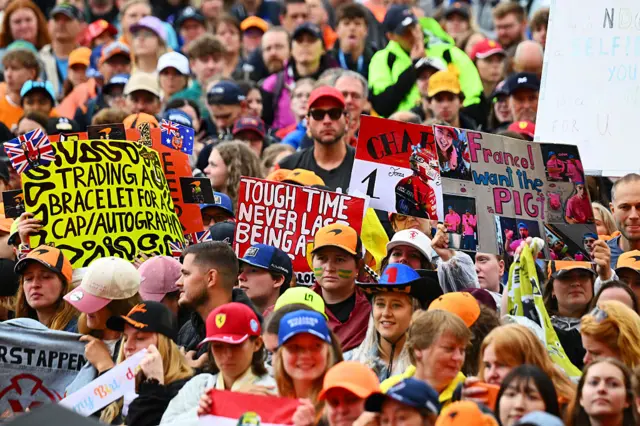 Fans hold up signs at Zandvoort ahead of the first day of the 2026 Dutch Grand Prix weekend