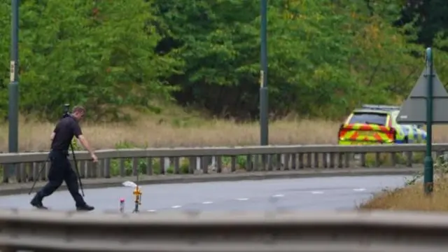 A police officer at the scene of the fatal crash