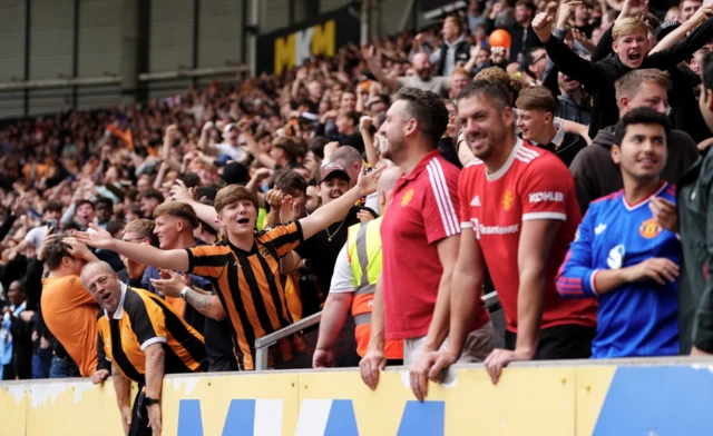 Hull City fans celebrate towards the Manchester United fans after Hull City's Nobel Mendy scores their side's second goal of the game during the Premier League match at the MKM Stadium, Kingston upon Hull.