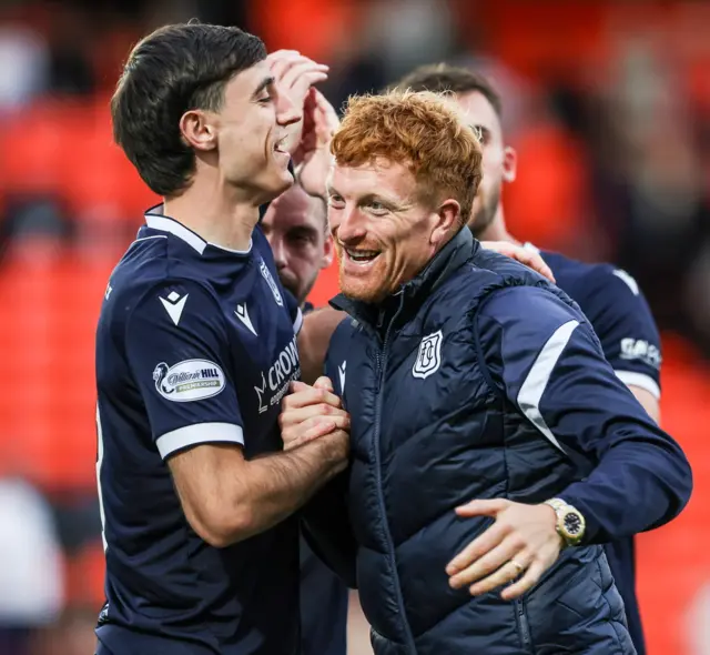 Dundee players celebrate three points at Tannadice