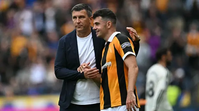 Hull City's Bosnian manager Sergej Jakirovic (L) congratulates Hull City's Irish defender #15 John Egan (R) on the pitch after the English Premier League football match between Hull City and Manchester United at the MKM Stadium.