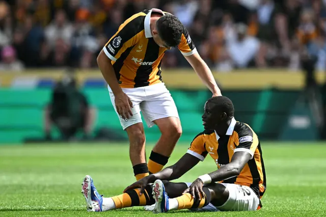 Hull City's Senegalese defender #32 Nobel Mendy sits after picking up an injury during the English Premier League football match between Hull City and Manchester United at the MKM Stadium.