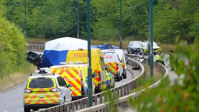 Police officers at the scene of a fatal crash involving a police car and a Volkswagen Passat on the A66 in South Bank, near Middlesbrough