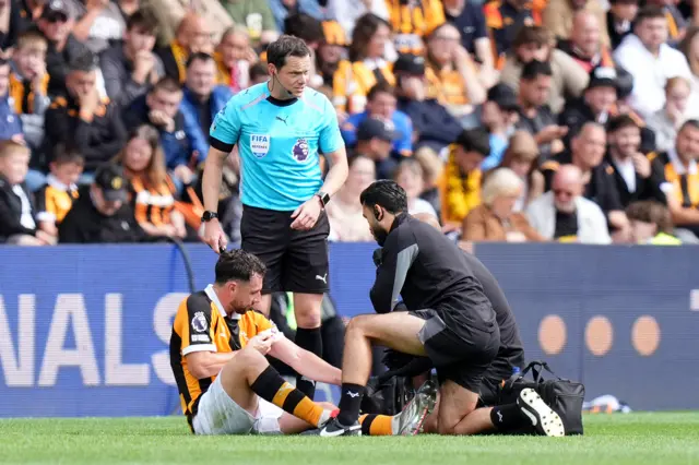 Hull City's Lewis Coyle (left) is treated by medical staff before being substituted with an injury during the Premier League match at the MKM Stadium, Kingston upon Hull