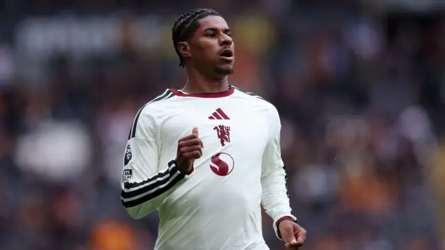 Manchester United's Marcus Rashford warms up during half time.