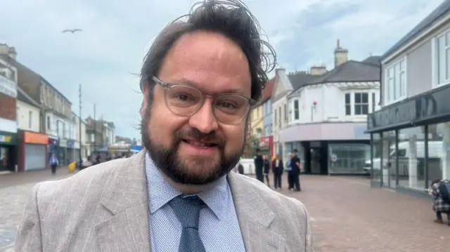 PCC Matt Storey pictured in May 2026 in a grey suit with brown hair and clear spectalces