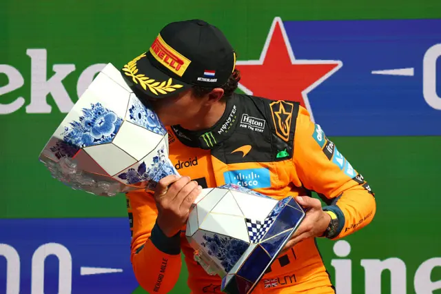 Lando Norris kisses the Dutch GP trophy