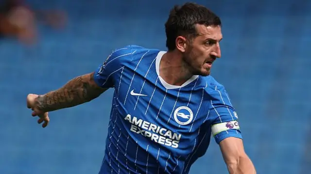 Lewis Dunk of Brighton & Hove Albion controls the ball during the pre-season friendly match between Brighton & Hove Albion and AS Roma at American Express Stadium.