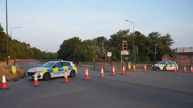 Police cars and cones closing the A66 near South Bank, Teesside following a fatal crash involving a police car and a Volkswagen