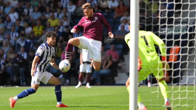 Jacob Bruun Larsen (centre) jumps in the air to kick the ball towards goal