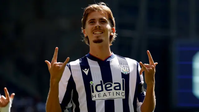 Isaac Price celebrates scoring by doing the rock on sign with his hands