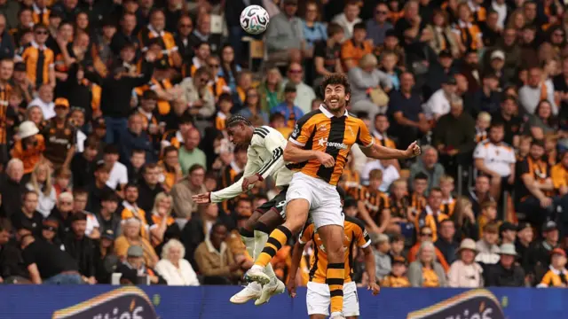 Harry Crooks and Marcus Rashford challenging to head the ball