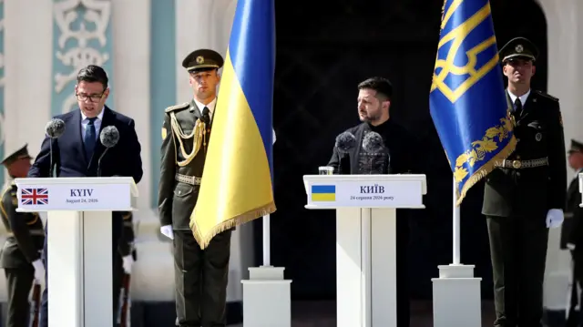 Britain's Prime Minister Andy Burnham delivers a speech next to President Volodymyr Zelenskiy