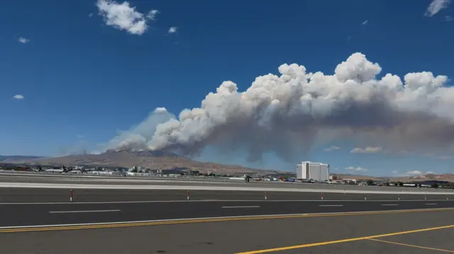 Smoke rises from hills during the Hawk Fire burning in Washoe County, Nevada