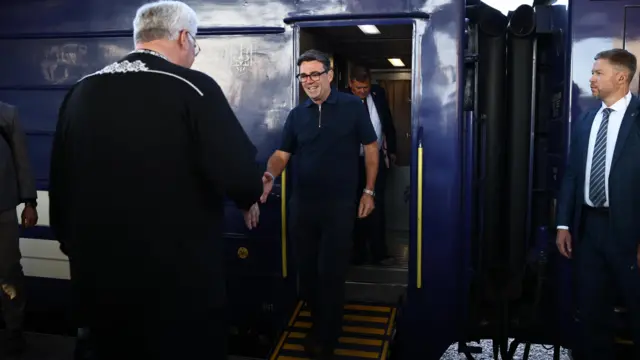 Ukraine's Foreign Affairs Minister Andrii Sybiha (left) welcomes the UK's prime minister as he arrives by train in Kyiv