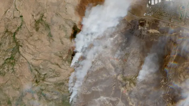 A satellite image shows smoke rising in an area as the Hawk Fire burns in Reno, Nevada