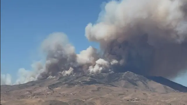 Smoke rises from hills during the Hawk Fire burning in Washoe County, Nevada