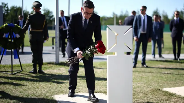 Burnham lays flowers at the tomb of the unknown Ukrainian soldier during a ceremony at Ukraine's national military memorial cemetery