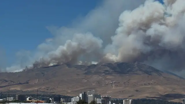 Smoke rises from hills during the Hawk Fire burning in Washoe County, Nevada, U.S., August 22, 2026