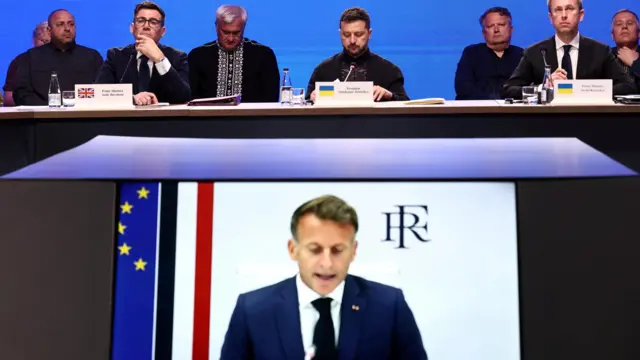 British Prime Minister Andy Burnham, Ukraine's President Volodymyr Zelenskiy and Ukraine's Prime Minister Sergii Koretskyi react as they listen to France's President Emmanuel Macron speaking via video conference during the Coalition of the Willing meeting, in Kyiv