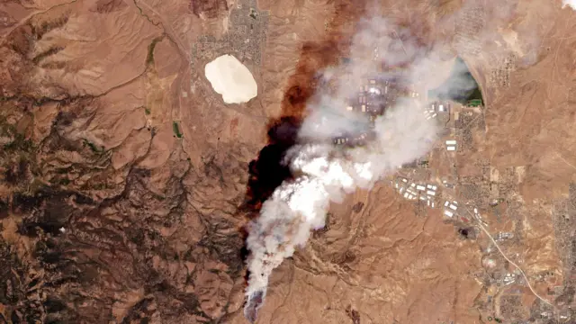 A satellite image shows smoke rising from an area as Hawk Fire burns in Reno, Nevada, U.S., August 22, 2026